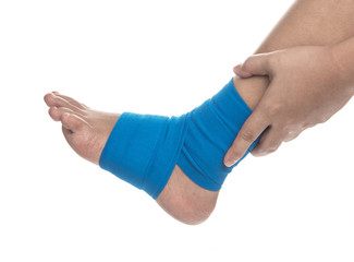 Ankle wrapped in elastic bandage on white background,Ankle pain