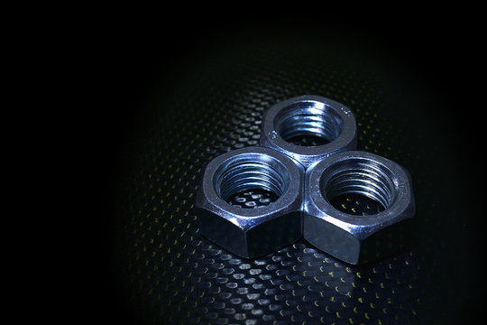 Three nuts on carbon background
