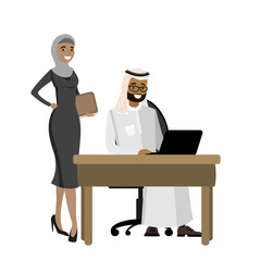 Arabic businessman working at a laptop and business woman standing