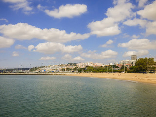 Blue and cloudy sky at Alges beach in the summer (Lisbon, Portugal)