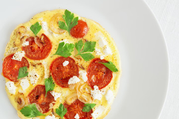 eggs fried with tomatoes, onion, parsley, and feta