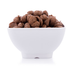 chocolate cereals in white bowl on white background. Cornflakes