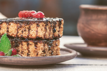 Tasty chocolate cake with berries on table close up