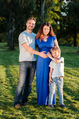 Fototapeta premium Happy pregnant family of three expecting new baby