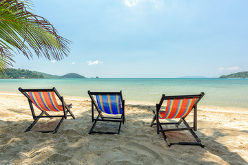 Beach chairs on the white sand beach and tropical sea