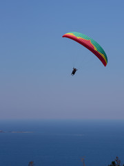 Flying tandem paragliders in the sky over the sea and near the mountains, beautiful sea view 07