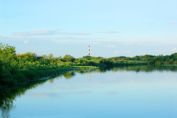 River, Bank and factory chimney in the distance