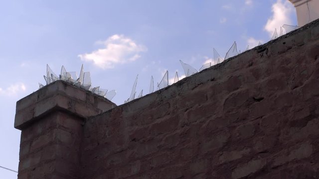 protected area with bick wall and sharp glass