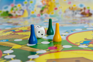 Blue, yellow and green plastic chips, dice and Board games for children .