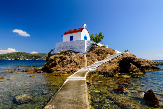 The picturesque Greek Islands. Chapel of St. Isidoros on a small rocky island near Leros island, Dodecanese, Greece