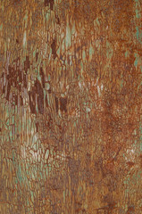 Weathered once painted metal surface with lot of rust