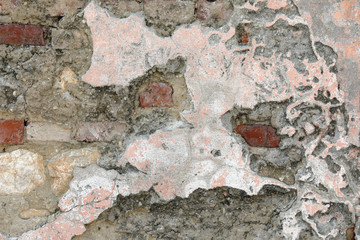 lime wall and brick with the ruined plaster of time