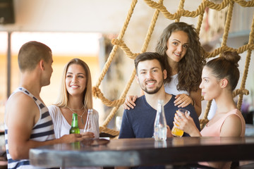 Group of friends having a drink at day party