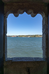 Fototapeta premium View through stone window across River Tagus, Lisbon
