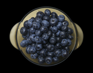 Healthy food fresh blueberries in a bowl on a black background
