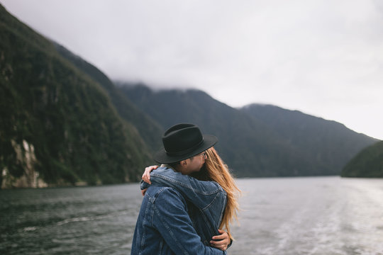 Couple hugging with the beautiful Milford Sound in the background