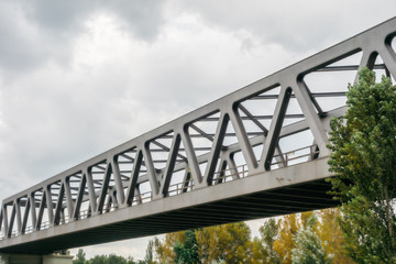 modern steel bridge with green trees