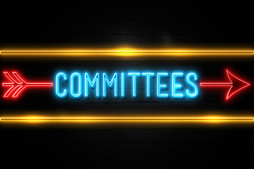 Obraz premium Committees - fluorescent Neon Sign on brickwall Front view