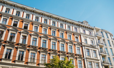 Fototapeta na wymiar orange brick facaded building with white frames