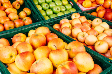 some red and green apples in boxes