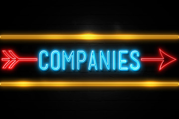 Companies  - fluorescent Neon Sign on brickwall Front view