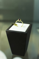 Beautiful golden ring in a shop window. Jewelry exhibit.
