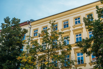 yellow building with green trees