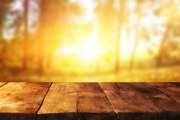 Empty table in front of blurry autumn background. Ready for product display montage