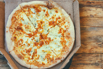 fresh pizza four cheeses in cardboard box