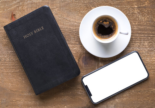 Holy Bible and smartphone with black coffee cup. Time for study concept. 