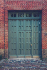 old green door on brick building