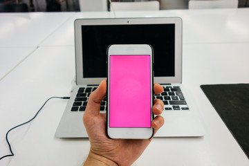 smartphone in the middle of a picture with notebook in the background