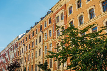 Fototapeta na wymiar warm colored brick buildings in a row at summer