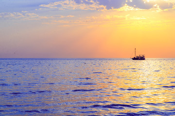 Fototapeta na wymiar orange sunset on the sea with boat