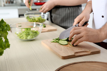 Chef giving cooking classes in kitchen