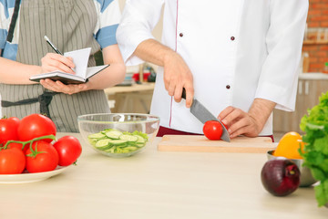Chef giving cooking classes in kitchen