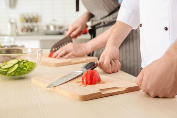 Chef giving cooking classes in kitchen