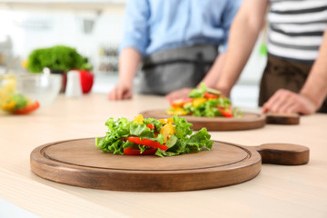 Board with delicious cut vegetables on table. Concept of cooking classes