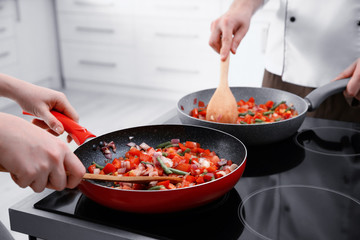 Chef giving cooking classes in kitchen