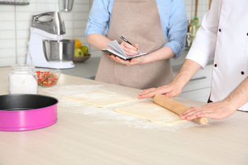 Chef giving cooking classes in kitchen