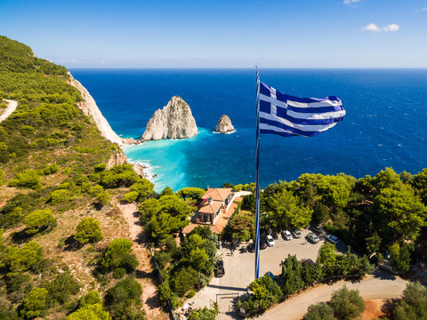 Greek biggest national flag waving in the sky in Keri in Zakynthos (Zante) island in Greece