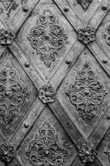 Black metal texture floral pattern background. Forging. Fasteners.