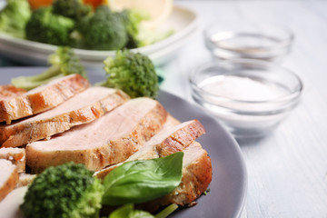 Plate with delicious sliced turkey fillet on table, closeup