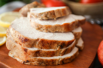 Delicious roasted turkey fillet on cutting board, closeup