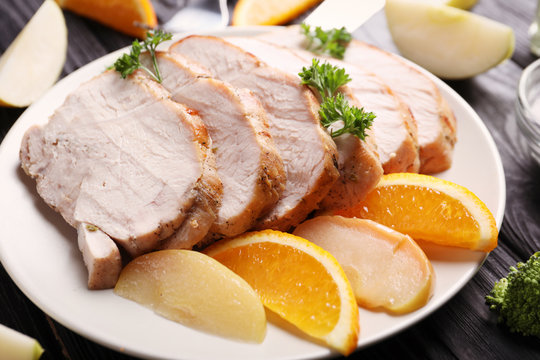 Plate with delicious sliced turkey fillet and fruits, closeup