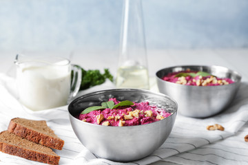 Bowls of fresh beet hummus on table