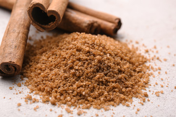 Composition with cinnamon sugar and sticks on light background
