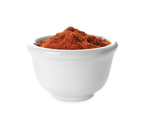 Pile of red chili powder in ceramic bowl isolated on white