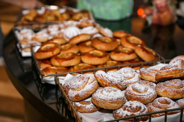 Different kinds of bakery products in baskets at buffet