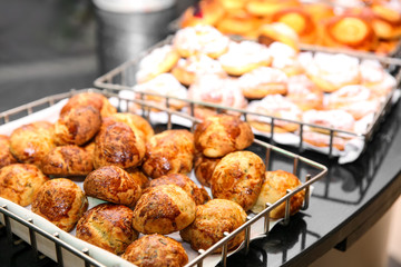 Different kinds of bakery products in baskets at buffet
